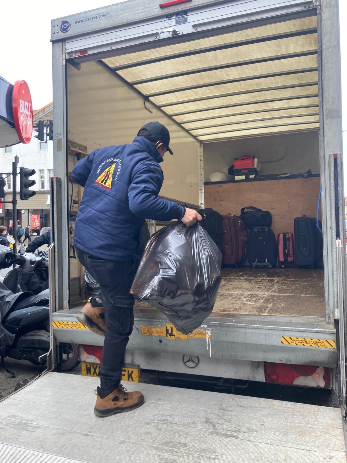 Man and van removals service with protective blankets securing furniture for transport in the Colliers Wood area
